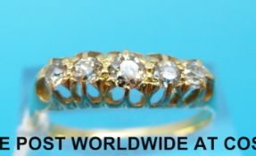 A 9ct gold ring set with four diamonds