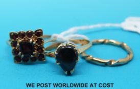 A 9ct gold ring set with red stones,