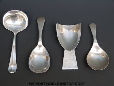 Three late 19thC / early 20thC hallmarked silver caddy spoons and a white metal example marked