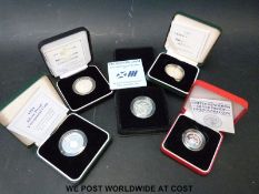 Five various cased silver proof coins comprising four £2 examples and a one pound coin