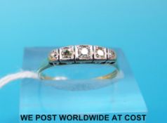 A yellow metal ring marked 9ct set with five diamonds in a platinum illusion setting (size M)