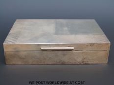 A hallmarked silver cigarette box with Art Deco style decoration (width 16.