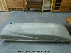 A fibre glass roof box and mounting bars