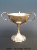 An Edward VII hallmarked silver Arts & Crafts three-handled bon bon dish of hammered design,