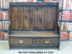 An 18thC elm settle with two drawers under (width 130cm)