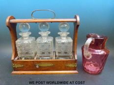 An oak three-bottle tantalus,