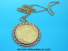 A 9ct gold pendant set with a 1915 medallion coin, on yellow metal chain (42.