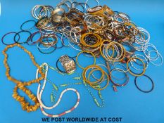 A large collection of costume jewellery to include amber necklace etc
