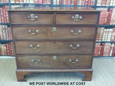 A Georgian mahogany straight fronted chest of two over three graduated drawers raised on bracket