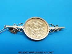 A 9ct gold brooch set with a 1910 gold full sovereign (12.