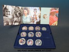 A cased collection of enamelled 22ct gold plated picture coins featuring the Queen's Diamond