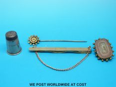 A 9ct gold tie clip, yellow metal stick pin set with a diamond,