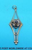 A 9ct gold pendant set with a sapphire and diamonds in a cluster