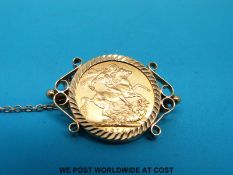 A 9ct gold brooch set with a 1914 gold full sovereign (10.