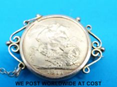 A 9ct gold brooch set with a 1911 gold full sovereign (10.
