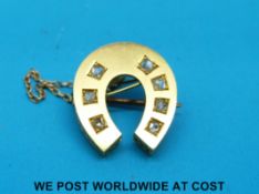 A Victorian horse shoe brooch set with diamonds
