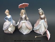 Three Lladro ladies with parasols