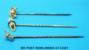 A yellow metal stick pin marked 9ct,