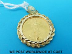 A 2000 Liberty 1/4oz ten dollar coin in yellow metal mount marked 14k (13.