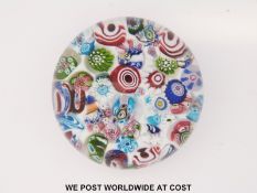 Clichy scrambled millefiori glass paperweight with various multicoloured canes on a 'sodden snow'