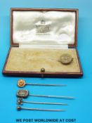 A Victorian stick pin with a round top set with five old cut diamonds,