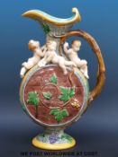 A Minton majolica ewer in the form of a barrel with figural putti decoration (38cm tall)