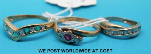 Three 9ct gold rings, one set with a ruby and diamonds and one emeralds and diamonds.