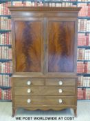 A Georgian flame mahogany linen press with slide-out trays to top and two over two drawers to base