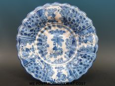 A Dutch Delft shallow lobed bowl decorated with chinoiserie scenes (5.