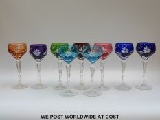 A set of eight flash overlaid hock glasses with cut decoration of flowers and foliage raised on