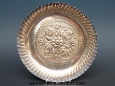 A Victorian hallmarked silver embossed circular dish, B'ham 1888, maker possibly Vale Bros & Sermon,