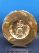 A 19th/20thC Spanish brass relief moulded charger on stand,