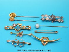 Two Victorian stick pins marked 15ct, another stick pin set with an opal,
