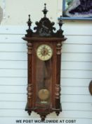 A German Vienna regulator style wall clock with carved deer decoration to top