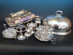 A quantity of silver plated items to include meat dome, swing handled basket, egg set, peppers,