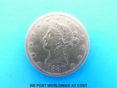 An 1887 gold ten dollar coin