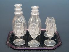 A 19thC miniature drinks set on purple glass tray (length 7cm) comprising two decanters and four