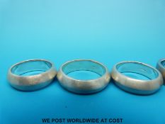 Four silver rings with matt finish