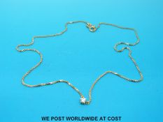 An 18ct gold necklace set with a diamond (4.