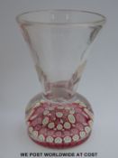 An old English glass crown paperweight vase, the base weight with five rings of alternating pink,