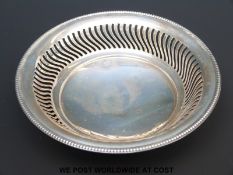 A hallmarked silver pierced bonbon dish raised on three ball feet, Birmingham 1911,