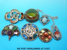 Six Miracle brooches and a similar pendant