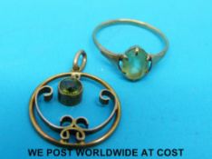 A yellow metal pendant set with a peridot and a 9ct gold ring set with a peridot