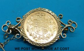 A 9ct gold brooch set with a 2002 gold full sovereign (12.