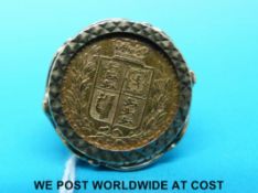 A 9ct gold ring set with an 1884 shield back gold full sovereign (14.