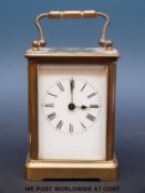 A brass cased corniche style carriage clock with oval top,