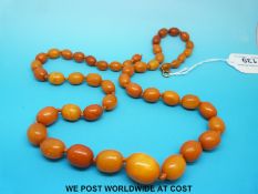 A graduated amber necklace made up of 48 oval beads of butterscotch colour, 44g.