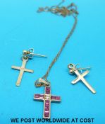 A 9ct gold cross set with rubies and a diamond on a 9ct gold chain with a pair of 9ct gold earrings