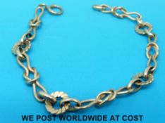 A 9ct gold bracelet in the form of knots and circles (10.