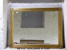 A gilt framed bevelled edge mirror (approximately 140cm x 110cm overall)